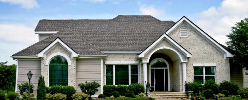 Gray and off-white brick home with tinted windows